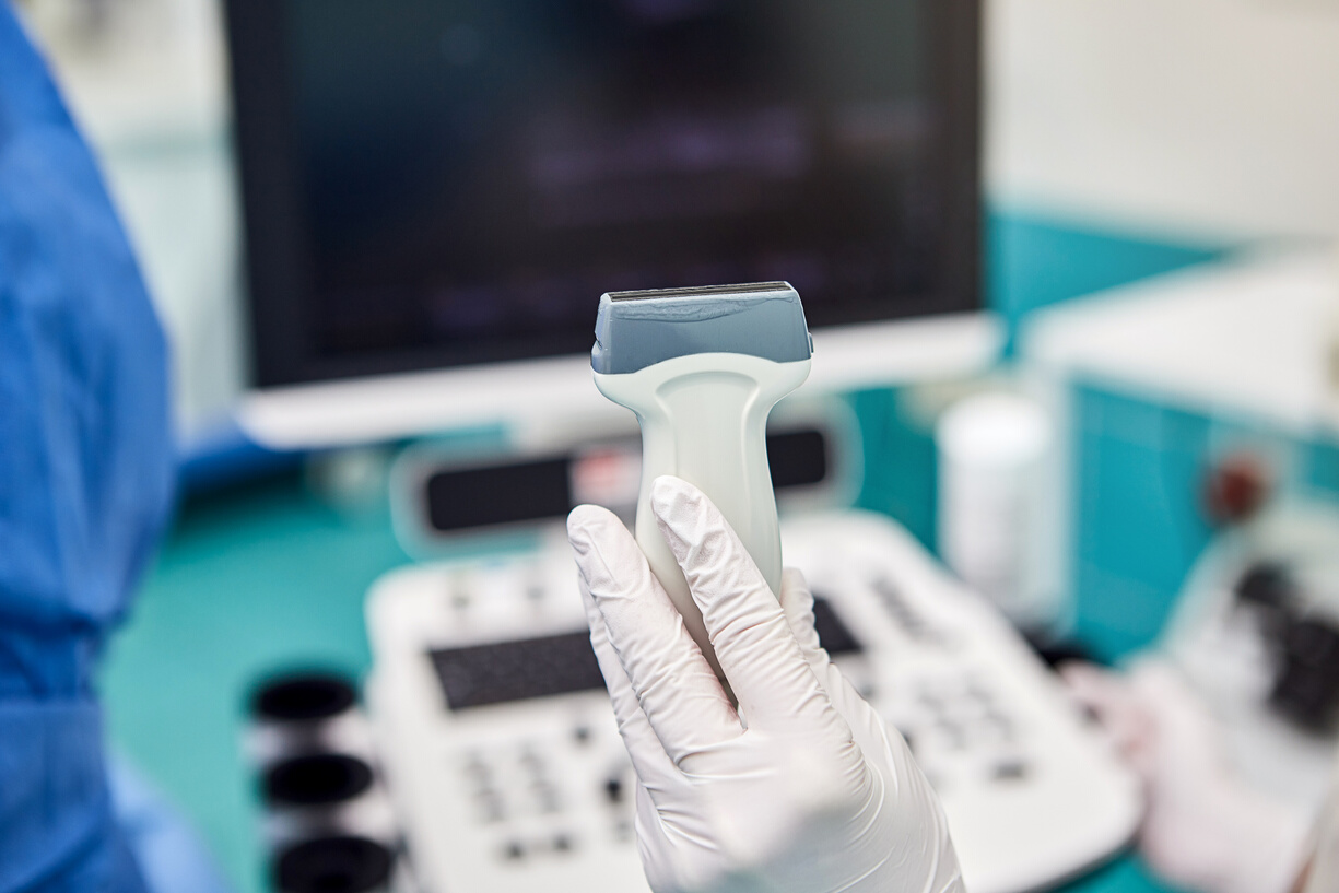 Doctor with medical equipment for ultrasound examination of leg veins. Phlebologist working in modern clinic with Varicose Veins disease